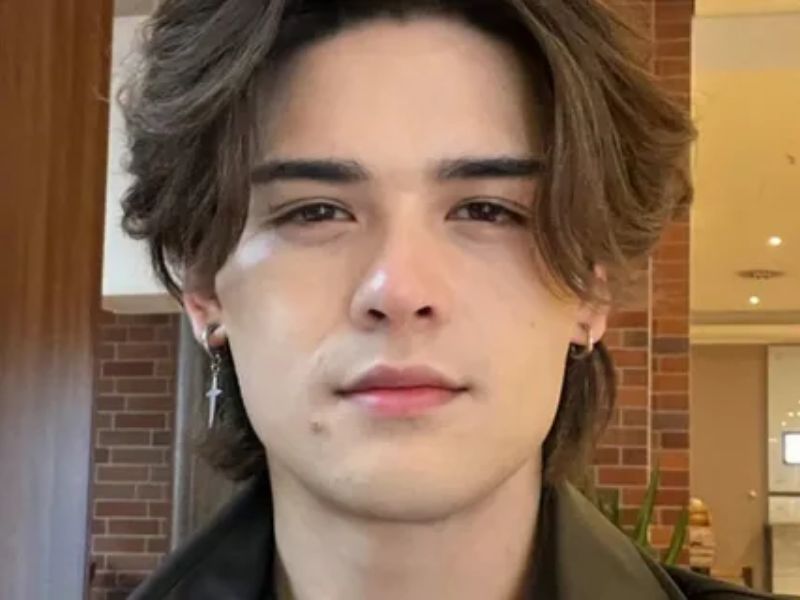 “Curly wolf cut hairstyle for men with layered textured curls”
