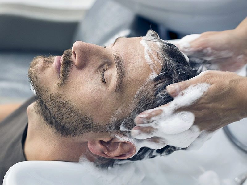 “Man washing and caring for long hair with healthy grooming routine”